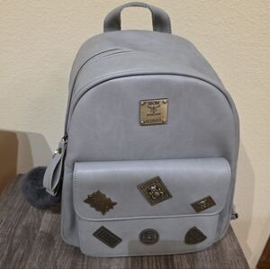 Light Gray Mini Backpack with Decorative Metal Accents and pom pom
